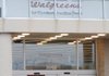 Customers walk in and out of the Walgreens store at 2002 S. Thompson St. in Springdale on Tuesday. Walgreens will be building its 13th store in Benton and Washington counties in the same style as this store in Springdale despite experimenting with alternative formats in other parts of the country.
