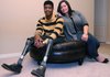 Sgt. Legrand Strickland, left, sits with wife, Carrie, on Wednesday in their Centerton home. Strickland was severely injured while serving with the 82nd Airborne on Feb. 2, 2010, when an explosive device hit the vehicle he was riding in while serving with the Army in Afghanistan. Strickland suffered a traumatic brain injury and lost both of his legs in the attack.
