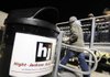 A student passes by a trash can Friday advertising a local sponsor at an entrance to the home seats at Tiger Stadium in Bentonville.
