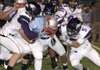 Fayetteville defenders wrap up Fort Smith Southside running back David Price Friday night at Jim Rowland Stadium. 