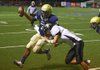 Pulaski Academy quarterback Fredi Knighten tries to get past Pottsville defender Michael Perry during Friday night’s Class 4A playoff game. 