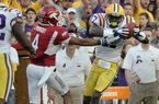 LSU's Morris Claiborne, right, makes an interception on a pass intended for Arkansas' Jarius Wright during an NCAA college football game in Baton Rouge, Friday, Nov. 25, 2011. LSU defeated Arkansas 41-17.