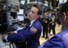 Specialist Christopher Trotta (left) works Monday on the floor of the New York Stock Exchange. Hopes for a more far-reaching solution to Europe’s debt crisis and a strong start to the Christmas shopping season sent stocks sharply higher Monday. 