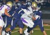 The Greenwood defense led by #57 Cole Gassman, #56 Howie Cox and #44 Saul Palmer wrap up #5 Benjamin Shields of CAC for a loss.  