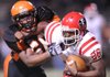 STAFF PHOTO ANDY SHUPE -- Farmington quarterback Deon Clay, right, reaches to fend off Malvern defensive lineman Isaac Wright Friday, Dec. 2, 2011, during the first half of play at Claude Mann Stadium in Malvern.