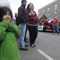 Reese Denson, 4, of Bentonville watches floats go by Saturday during the Christmas parade in Bentonv...