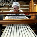 Carol Alford of Fayetteville weaves a table runner during a previous Christmas Open House at Prairie...