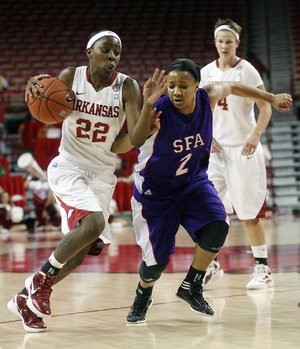 Arkansas guard C’eira Ricketts (22) drives to the basket against Stephen F. Austin’s Courtney Conwright (2) during the Razorbacks’ 61-46 victory Tuesday at Walton Arena in Fayetteville. 