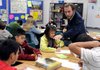 Justin Keen, social studies teacher at Helen Tyson Middle School, instructs students on an assignment about perspectives Tuesday in Springdale. The students were learning about the Little Rock Nine and needed to come up with different views of people who could be involved in desegregation. Keen, as well as other teachers at the school, work with English as a Second Language students. The students have the same educational requirements when taking standardized tests. The Springdale School District works to make sure their comprehension of school subjects is on par with other students.