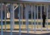 A Springdale police officer guards an entrance to Bernice Young Elementary School in Springdale on Wednesday after the school was locked down at the end of the day because of a threatening text message received by the mother of a student at the school.
