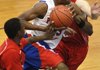 Little Rock Parkview’s Emmanuel Adoyi (center) drives between Clarksville’s Freddy Lee (left) and Trey Norris during the Jammin’ for Jackets basketball tournament at North Little Rock High School. 