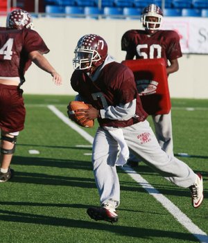 Barton quarterback Laquarius Hall runs a drill during practice Wednesday at War Memorial Stadium in Little Rock. The Bears will take on the Charleston Tigers in tonight’s Class 3A championship game. 
