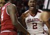 Oklahoma guard Steven Pledger (2) reacts after sinking a basket and drawing a foul call against Arkansas in the second half of an NCAA college basketball game in Norman, Okla., Saturday, Dec. 10, 2011. Oklahoma won 78-63. Arkansas forward Devonta Abron is at left. (AP Photo/Sue Ogrocki)