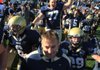 Pulaski Academy Coach Kevin Kelley (bottom) and his players, including senior offensive tackle Jason King (77), celebrate following Saturday’s victory over Malvern in the Class 4A state championship game at War Memorial Stadium in Little Rock. The Bruins finished the season 14-0. 