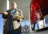 David Ricci, who owns a Ford Crown Victoria that runs on natural gas, holds a fueling hose Thursday at the natural gas filling station in North Little Rock. 