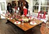 Dena Brown, left, of Booneville tours the dining room of the Magnolia Gardens Bed and Breakfast during the Junior League Winter Holiday Tour of Homes in Springdale on Dec. 4. At right is Junior League volunteer tour guide Allison DeJarnette. The dining room was decorated by the Domus Design Group of Fayetteville.

