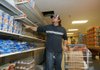 Richard DeWitt, pantry supervisor at Helping Hands of Bentonville, selects items to fill a shopping cart last week for a family in need. Helping Hands is serving about 100 families each day, and with donations down, it is buying more of its own food.