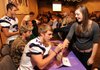 Fayetteville’s Brooks Ellis, center, a junior linebacker autographs sophomore Natalie Watson, right, arm Tuesday during a celebration for the Bulldogs’ 2011 football state championship at the Fayetteville Town Center.