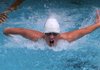Jacob Carroll races down the length of the pool Monday during a relay at John Brown University’s Walton Lifetime Health Complex pool in Siloam Springs.