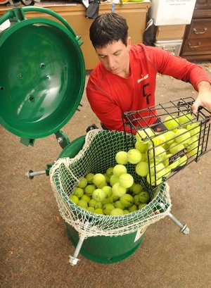 Jared Ward, co-owner of Ozark Tennis Academy, loads used tennis balls into a Green Tennis Machine to restore their bounce by repressurizing them with carbon dioxide. The patented machine is produced by Harrison-based reBounce Inc. and soon on its way to South America where it can be distributed and sold to Brazilian tennis clubs. The foreign business connection was facilitated by the Arkansas World Trade Center in Rogers.
