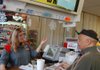 Arkansas Democrat-Gazette/BILL BOWDEN  12/12/11  David Mounsey of Fort Smith buys lottery tickets from Sissy Hensley, manager of Freddy's One Stop convenience store in Moffett, Okla. Freddy's was the No. 1 lottery ticket seller in Oklahoma before Arkansas's lottery started in 2009. Since then, Freddy's lottery ticket sales have dropped by 71 percent.
