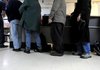 Clients line up to have their bags inspected and to take a breathalyzer test before entering the Salvation Army Emergency Shelter Tuesday, Dec. 6, 2011 at the shelter in Fayetteville.