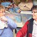 Compassion House's Jennie Martin, social services director, left, shows off a pair of infant pants t...