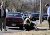 Rogers Cpl. Stan Cain, center, and Det. Brian Hanna, right, investigate the scene of a pedestrian hit and run accident Tuesday, Dec. 20, 2011, on West Sunset Drive near Northwest Park in Rogers. The victim, Oscar Cortez, was transported to Northwest Medical Center Bentonville for treatment of his injuries. The driver of the vehicle fled the scene and is being sought by Rogers Police.