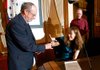 Julie Petty (right) returns Fayetteville Mayor Lioneld Jordan’s pen after taking the oath as a member of President Barack Obama’s President’s Committee for People with Intellectual Disabilities at the Fayetteville City Hall on Tuesday.