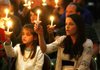 Arkansas Democrat-Gazette/WILLIAM MOORE
Kristin Davidson and her 10-year-old daughter Abby of Fayetteville hold candles while singing "Joy to the World during Christmas Eve services Saturday, December 24, 2011 at Central United Methodist Church in Fayetteville.