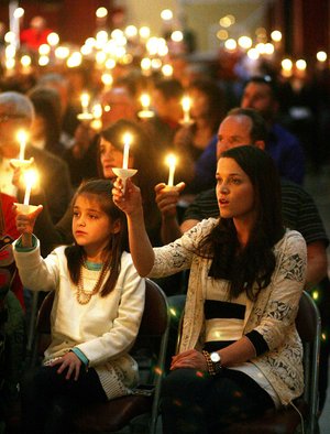 Arkansas Democrat-Gazette/WILLIAM MOORE
Kristin Davidson and her 10-year-old daughter Abby of Fayetteville hold candles while singing "Joy to the World during Christmas Eve services Saturday, December 24, 2011 at Central United Methodist Church in Fayetteville.