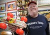 Bruce Fox, a toy historian and collector, shows off the first toy that started his collection, the 1960 Bouncy Racer, on Wednesday. Fox was working as a salesman in 1978 when he discovered the old toy on a client’s shelf and bought it for $1.20.
