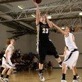 Whitney Sandmann of Bentonville, center, puts the ball up for two points over Purdy’s Katie Hughes d...
