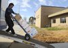 Jim O’Brien, with Winter Moving and Storage in Bentonville, moves boxes from the Benton County Election Commission into the commission’s new space in the county’s Public Service Building at 1204 S.W. 14th St. in Bentonville. Other county offices will begin moving in January as the county shifts out of leased space and into county-owned offices.
