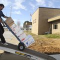 Jim O’Brien, with Winter Moving and Storage in Bentonville, moves boxes from the Benton County Elect...