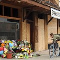 Adam Cogbill of Fayetteville pauses March 8 to read some of the notes left with a growing mound of f...