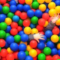 STAFF PHOTO SAMANTHA BAKER
An unidentifiable child reaches up after burying himself in the ball pit...