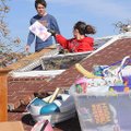 STAFF PHOTO DAVID FRANK DEMPSEY
Nichole Starr climbs out of a bedroom window to hand Jonathan Petti...