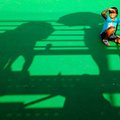 STAFF PHOTO MARC F. HENNING
Allison Williamson, 7, of Siloam Springs moves into the shade of her gr...
