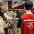 Lucas Hinch, left, shows Greg Bodenstein which pants he would like to purchase Dec. 20 at the Salvat...