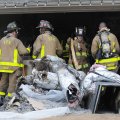ATTIC FIRE Fayetteville firefighters pile charred debris Friday from a home at 2417 Pierra Crossing ...
