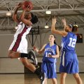Baiyinnah Taylor, Springdale High, left, takes the ball to the basket Friday past Carthage’s Kaylee ...