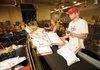 Andrew Davis, right, and Laura Curtis, processing clerks for the U.S. Postal Service, sort parcels on Dec. 22 at the facility in south Fayetteville.
