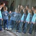 Kate Murr of Springfield, Mo., and her daughter Jane, 6, and son Brady, 4, are reflected in a window...