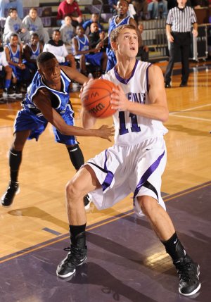 Kile Graves, Fayetteville senior, right, scores past Oklahoma City Southeast’s Roemello Roberson during the first half of play Dec. 16 at Fayetteville High.