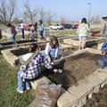 Students at Owl Creek School till and prepare garden beds for planting March 18 in Fayetteville.