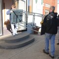 Ryan Gardner, left, and Hunter Collins move display stands into the new location for artist coop Poo...