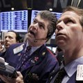 In this Dec. 20, 2011 file photo, traders John Panin, center, and Robert Charmay, right, work on the...
