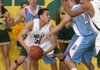Mills’ Braylon Spicer (30) gets caught between Fort Smith Southside’s Jonathan Hawley (30, facing) and Clayton Parkey (2) during the third quarter of Mills’ 57-39 victory Tuesday night.