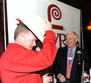 Arkansas Coach Bobby Petrino (left) tries on his Stetson hat during the Razorbacks’ version of the Lawry’s Beef Bowl on Monday night.